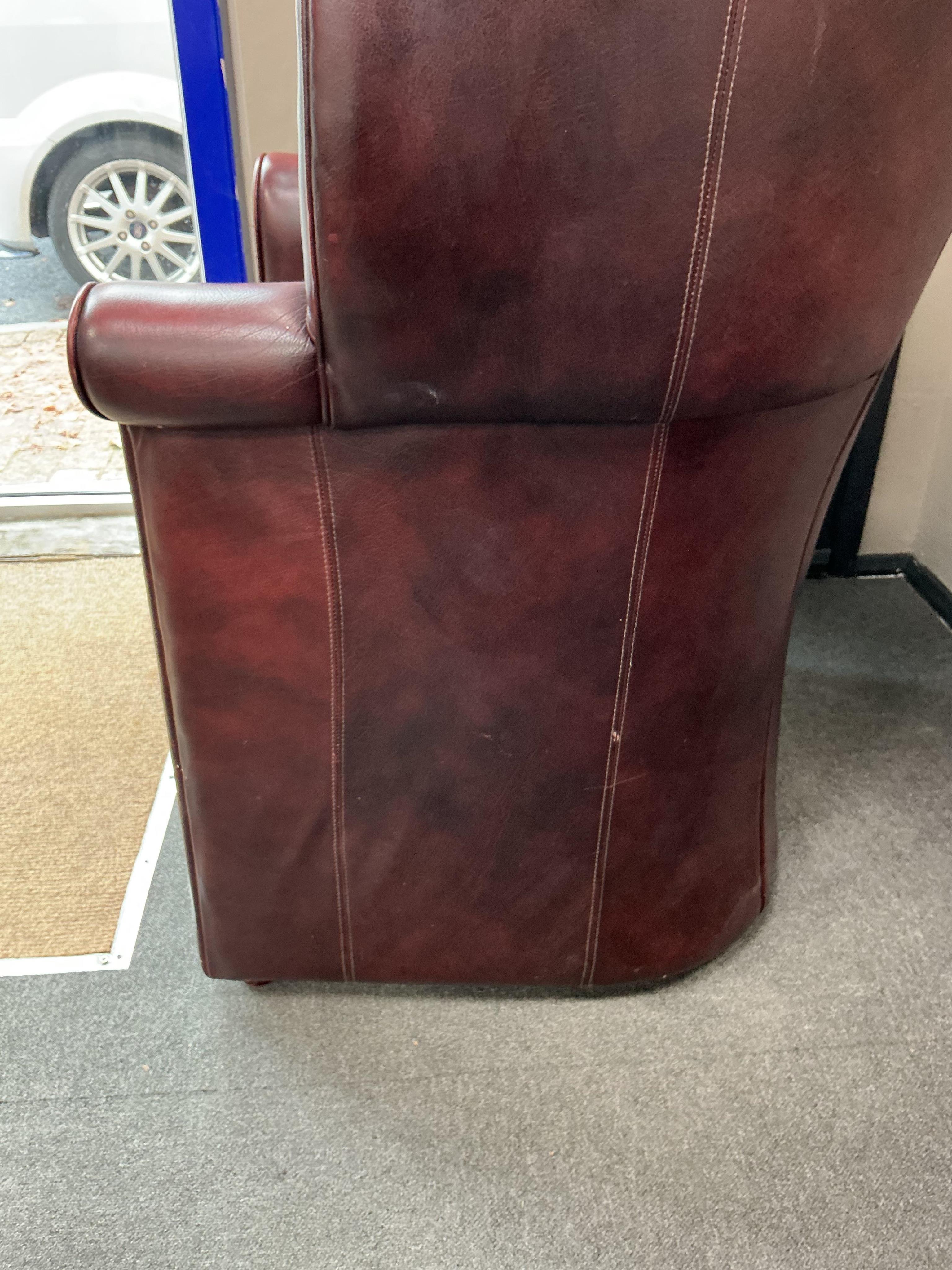 A reproduction buttoned burgundy leather hall porter's chair, width 88cm, depth 64cm, height 176cm